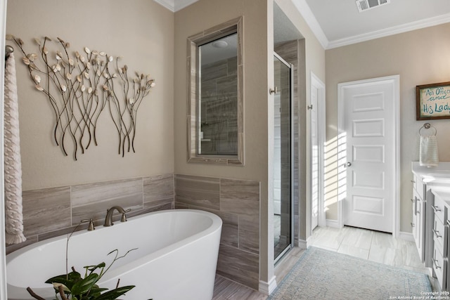 full bathroom featuring ornamental molding, visible vents, a stall shower, and a freestanding bath