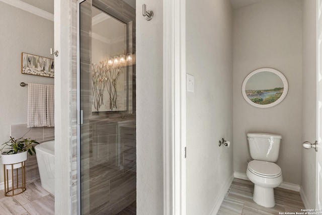 bathroom with a shower with shower door, baseboards, a soaking tub, and toilet