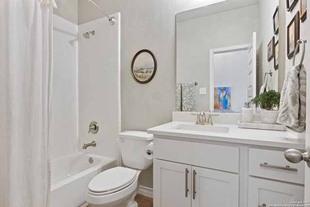 bathroom with vanity, shower / tub combo, and toilet