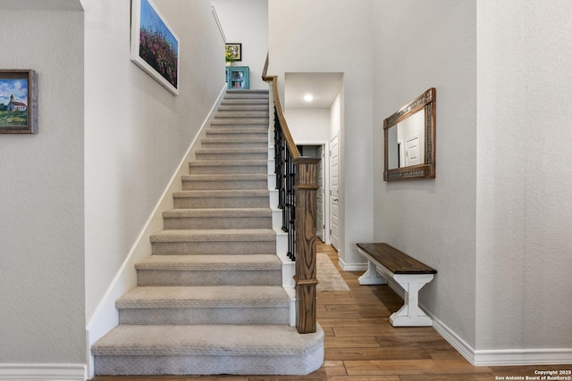 stairs featuring baseboards and wood finished floors