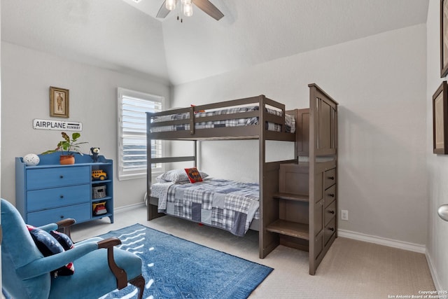 bedroom with light colored carpet, baseboards, lofted ceiling, and ceiling fan