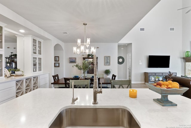 kitchen with visible vents, light countertops, and a sink