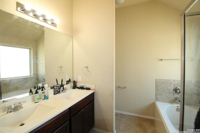 bathroom featuring tile patterned floors, a tub to relax in, and vanity