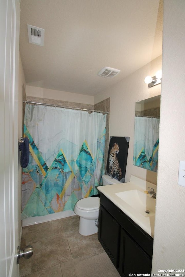 bathroom featuring vanity, curtained shower, and toilet