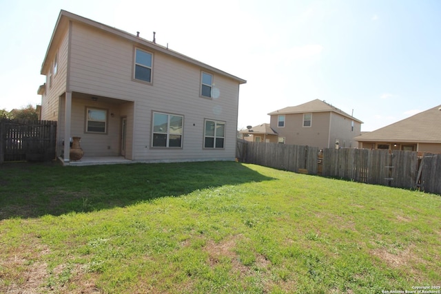 rear view of property with a lawn