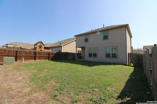 rear view of house with a lawn