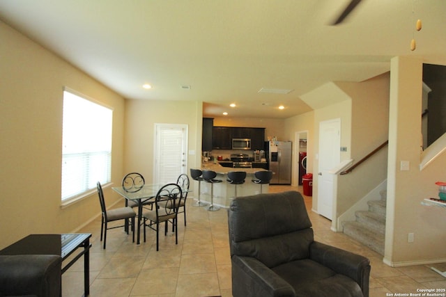 dining area featuring light tile patterned flooring