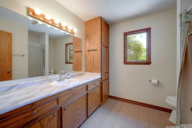 bathroom with tile patterned floors, vanity, toilet, and a shower with shower curtain