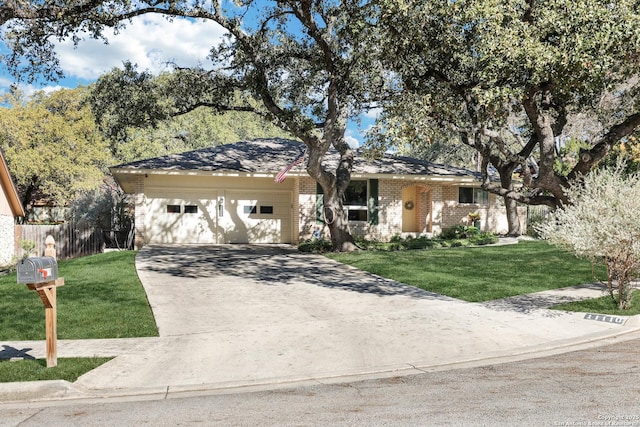 ranch-style house featuring a garage and a front lawn