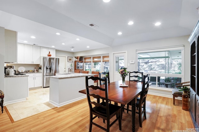 dining room featuring a wealth of natural light and light wood-type flooring