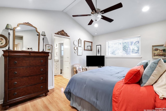 bedroom with ceiling fan, ensuite bath, lofted ceiling, and light wood-type flooring