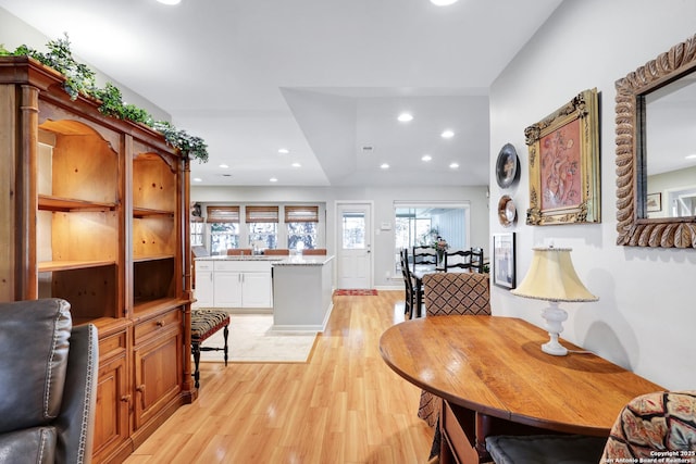 dining area with sink and light hardwood / wood-style floors