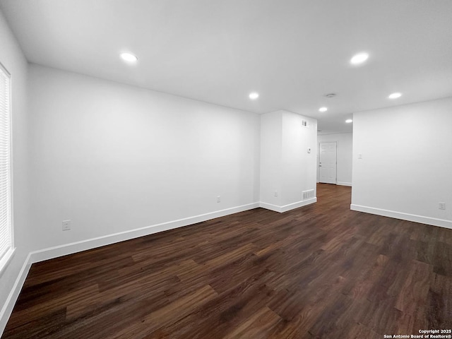 spare room with dark hardwood / wood-style floors