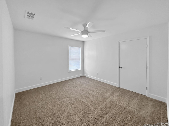 carpeted spare room with ceiling fan