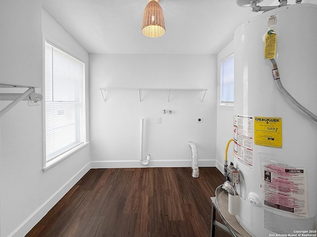 clothes washing area featuring hardwood / wood-style floors, a wealth of natural light, water heater, and hookup for an electric dryer