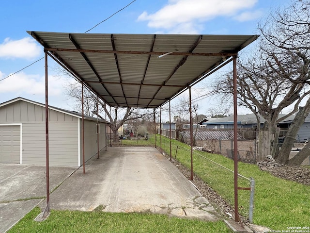 view of parking / parking lot with a garage and a lawn