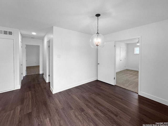 spare room featuring dark wood-type flooring