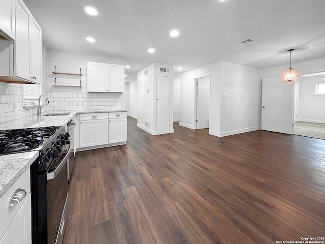 kitchen with white cabinetry, dark wood-type flooring, sink, and black gas range oven