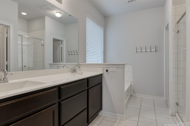 bathroom featuring vanity and separate shower and tub