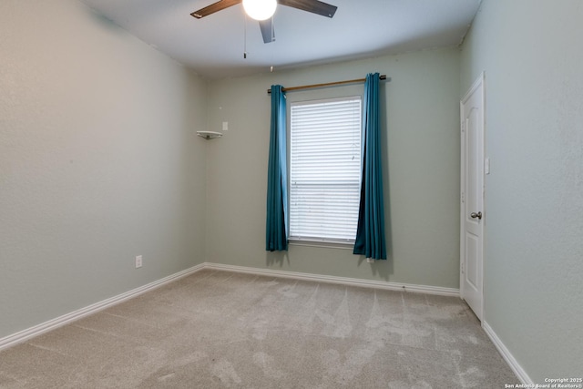 empty room featuring light colored carpet and ceiling fan