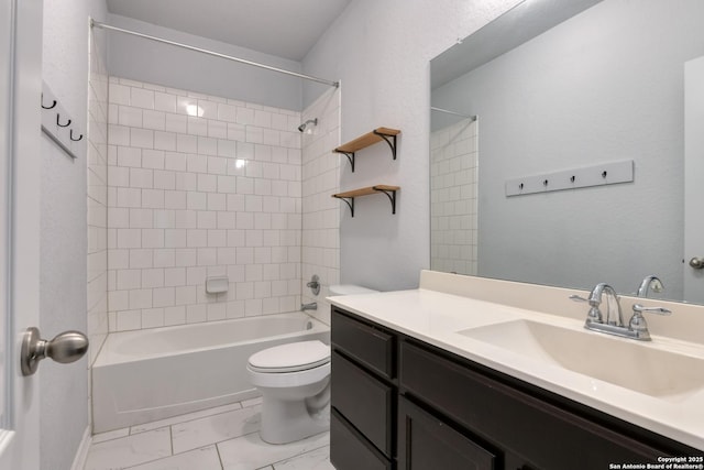 full bathroom with tiled shower / bath, vanity, and toilet