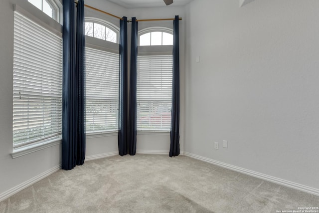 carpeted empty room featuring ceiling fan