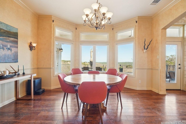 dining room featuring dark hardwood / wood-style flooring, crown molding, and plenty of natural light