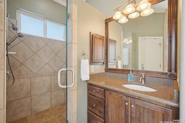 bathroom with a chandelier, vanity, and an enclosed shower