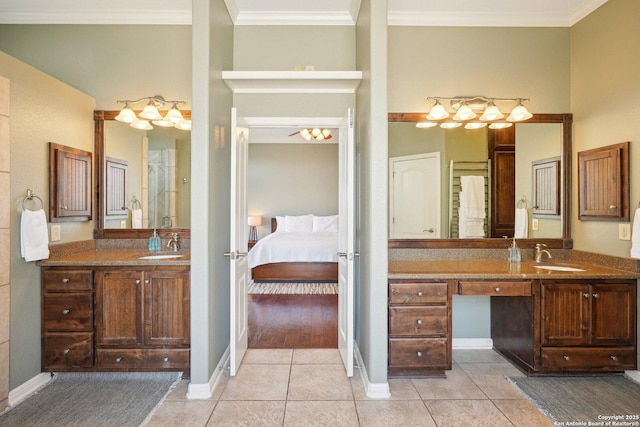 bathroom with tile patterned flooring, crown molding, and vanity