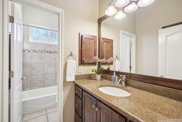 bathroom featuring tiled shower / bath combo, vanity, and tile patterned floors