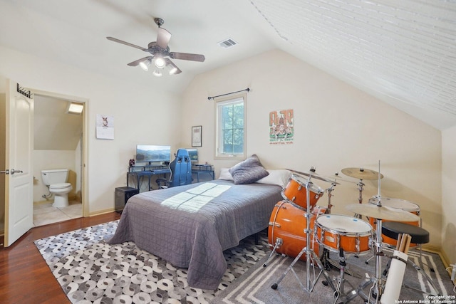 bedroom with lofted ceiling, hardwood / wood-style floors, connected bathroom, and ceiling fan