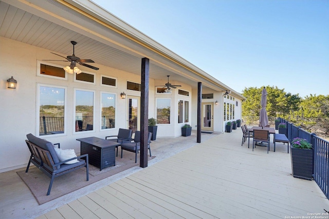 wooden deck featuring an outdoor living space with a fire pit and ceiling fan