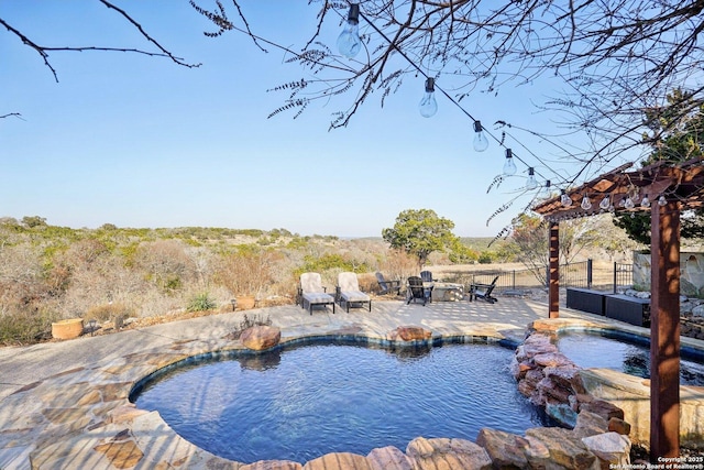 view of swimming pool with a pergola, a patio area, and an in ground hot tub