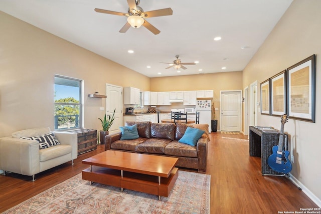 living room with ceiling fan and wood-type flooring