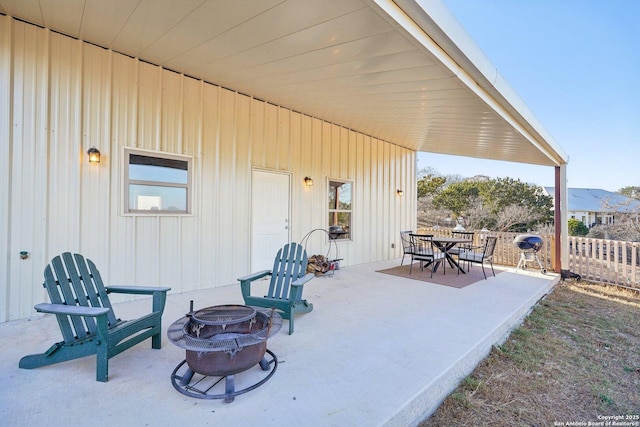 view of patio / terrace with a mountain view and a fire pit