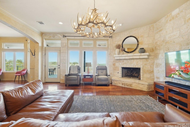 living room featuring ornamental molding, dark wood-type flooring, and a fireplace