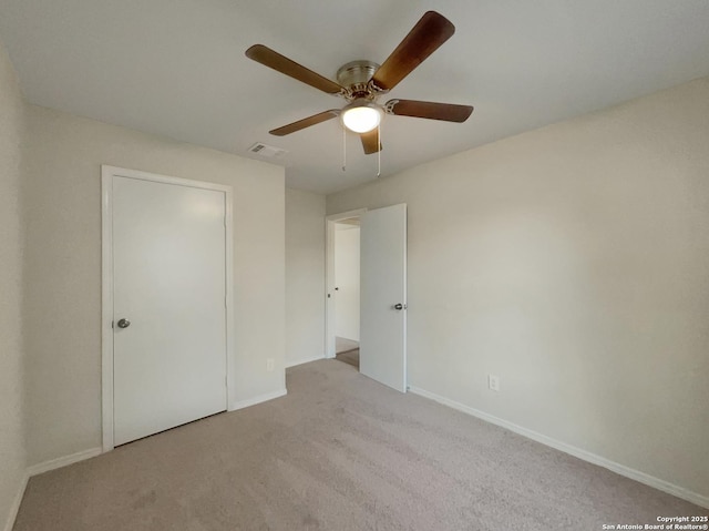 unfurnished bedroom featuring light colored carpet and ceiling fan