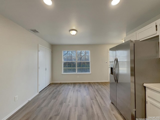 kitchen featuring white cabinetry, stainless steel refrigerator with ice dispenser, and light hardwood / wood-style flooring