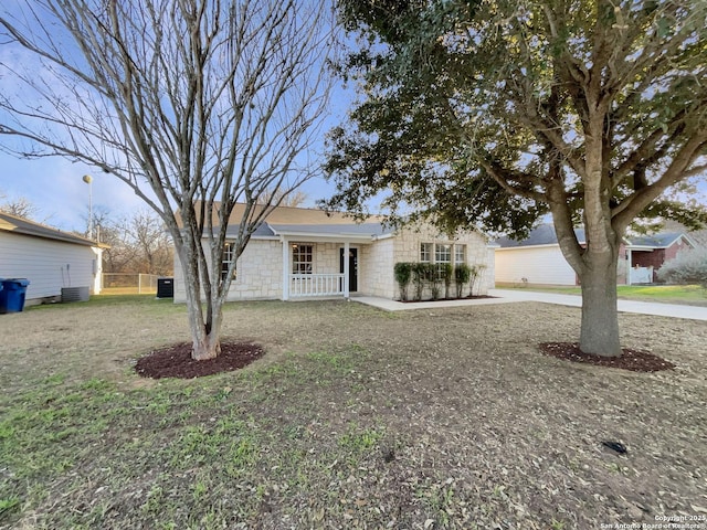 single story home with central AC, a front yard, and covered porch