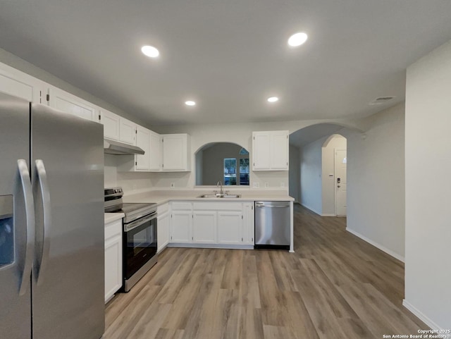 kitchen featuring white cabinetry, appliances with stainless steel finishes, sink, and light hardwood / wood-style flooring