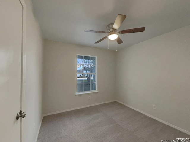 empty room featuring light carpet and ceiling fan