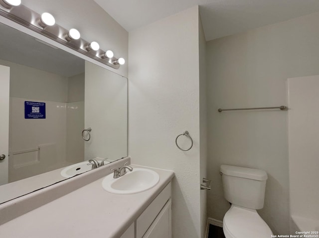 bathroom with vanity, toilet, and a shower