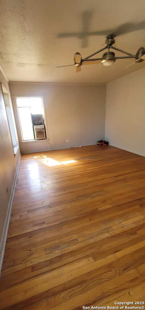 spare room with hardwood / wood-style flooring and ceiling fan