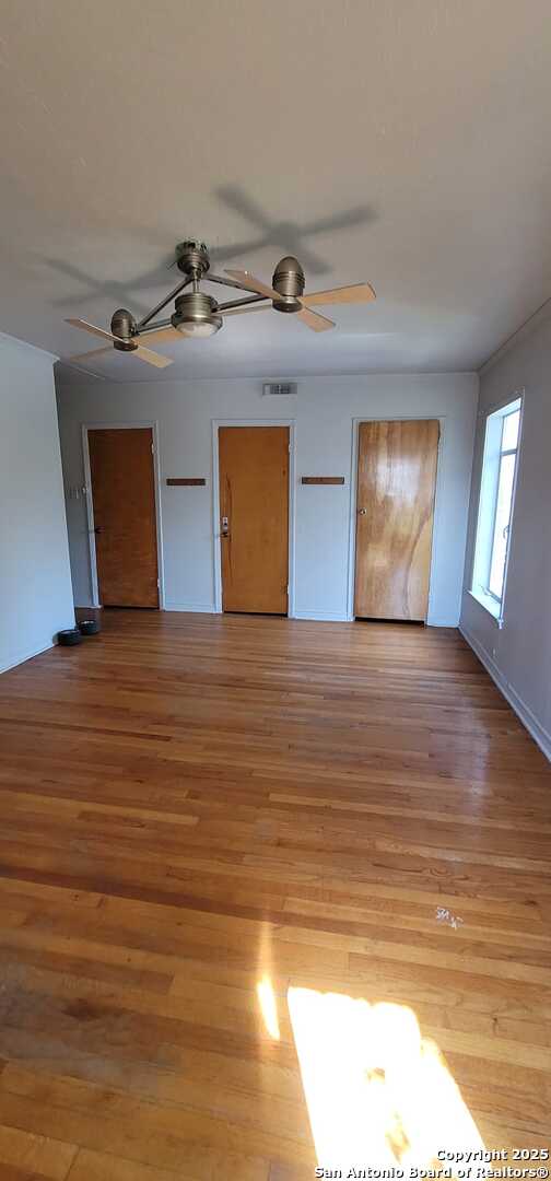 unfurnished bedroom with ceiling fan and light hardwood / wood-style floors