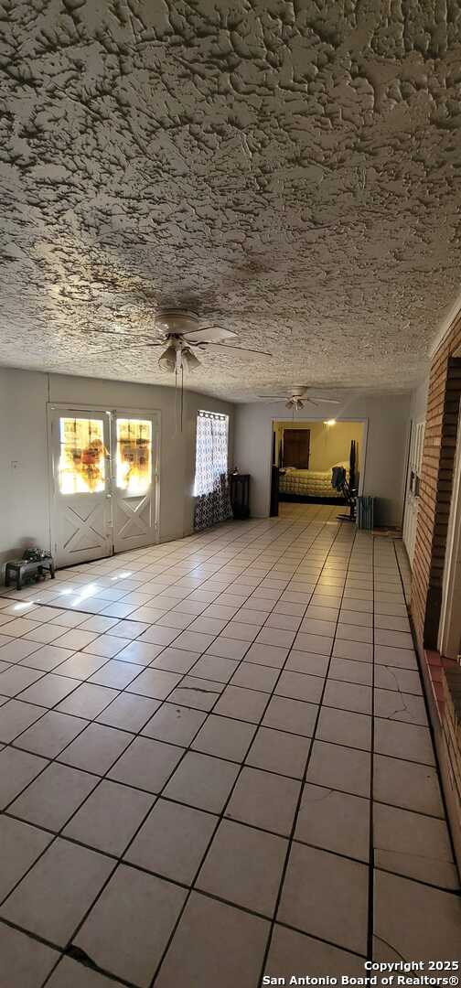 tiled empty room with a wealth of natural light