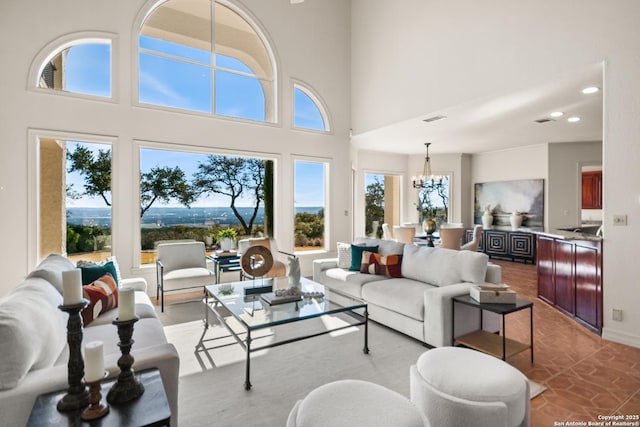 living room featuring a high ceiling and a chandelier