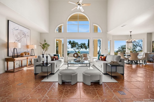 living room with ceiling fan with notable chandelier