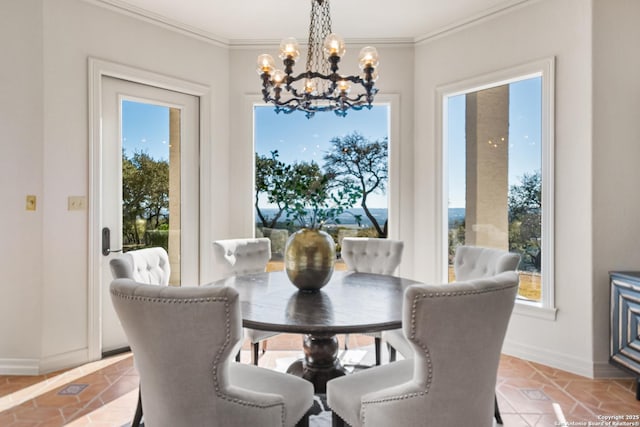 dining space featuring ornamental molding and an inviting chandelier