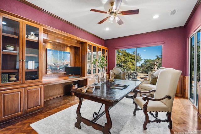 office space featuring dark parquet flooring, ornamental molding, and a healthy amount of sunlight