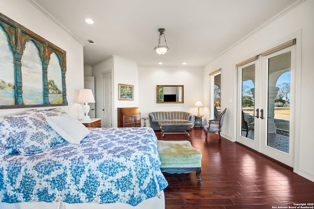 bedroom featuring dark hardwood / wood-style flooring, access to outside, ornamental molding, and french doors